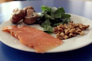 Combat acne by increasing zinc in your diet with healthy foods like salmon, spinach, nuts, or mushrooms!