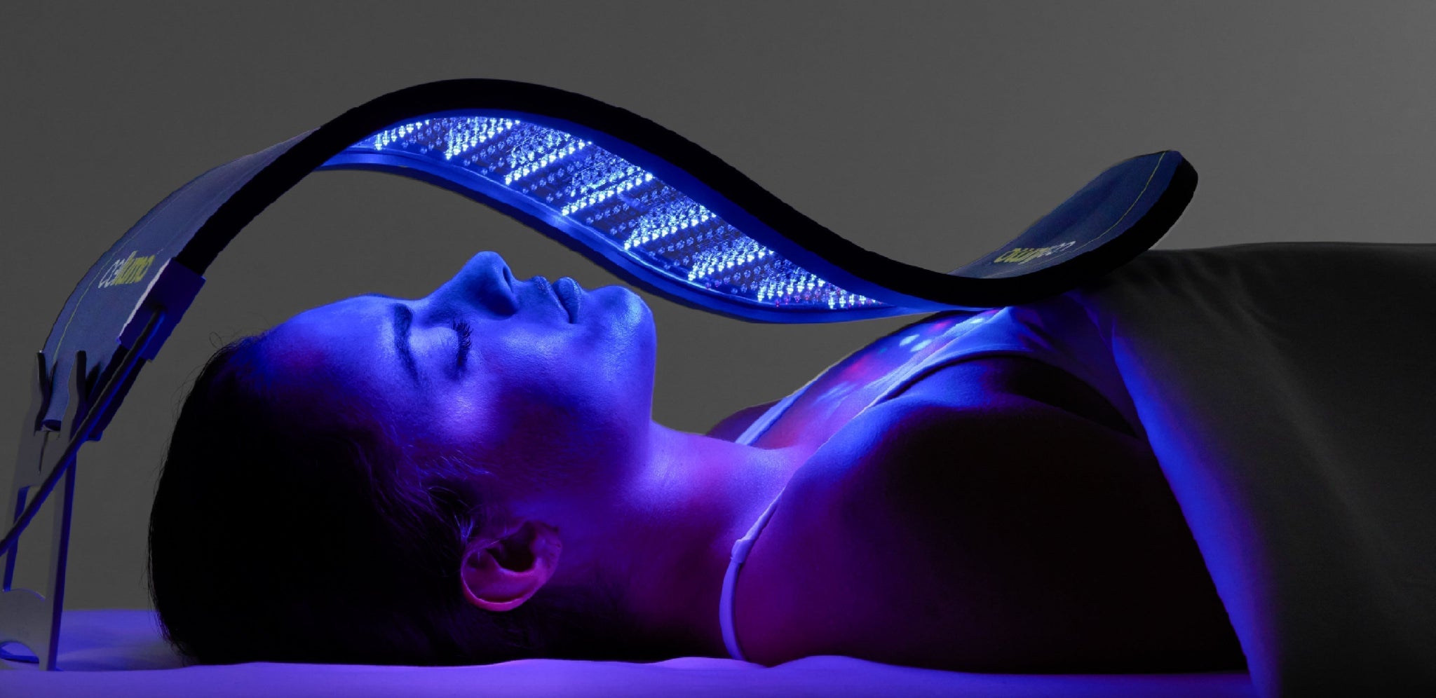 Woman receiving LED Light Therapy with a Celluma PRO device to help improve acne, skin aging, and skin healing.